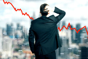 Back view of stressed young businessman looking at downward red arrow on blurry city background. Decrease, stats and economy concept. Multiexposure