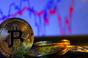 A golden bitcoin with keyboard and graph background. trading concept of crypto currency